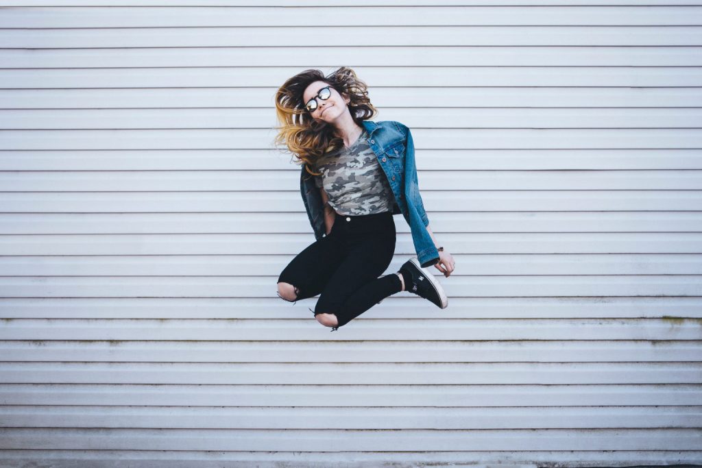 Woman jumping with house background