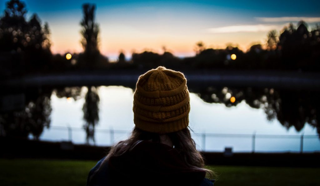 Women's back of head with sunset in background