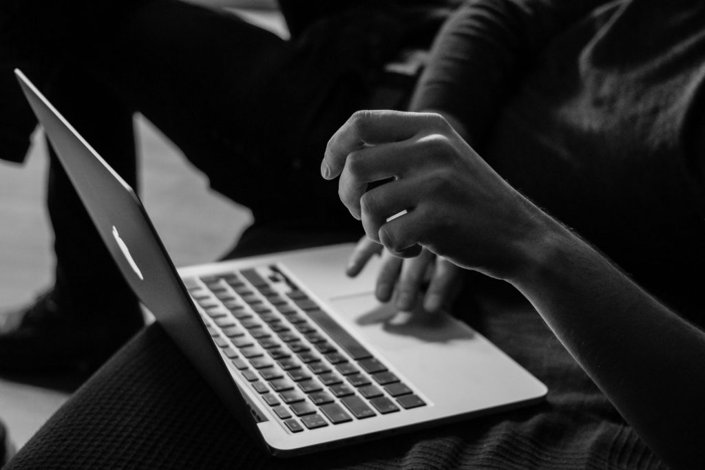 Hands typing on laptop