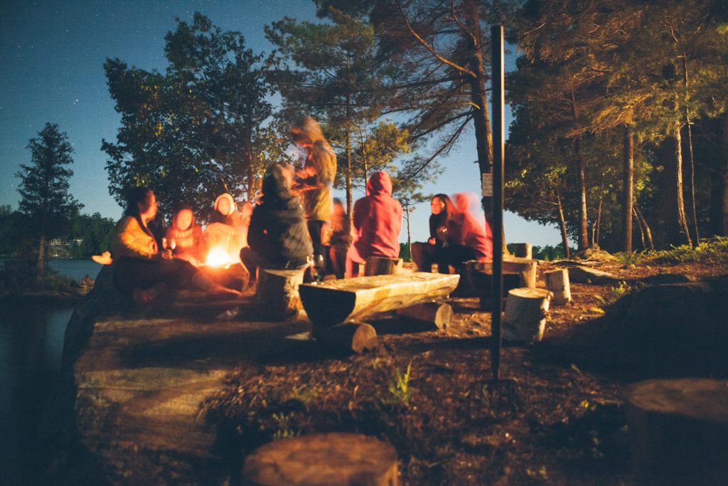 Group sitting around campfire